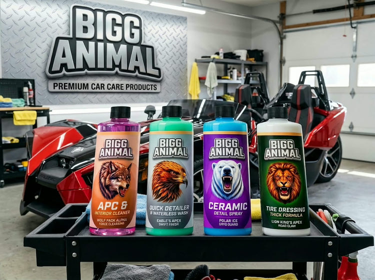 BIGG ANIMAL Core 4 bottles on a detailing cart in front of a red Polaris Slingshot